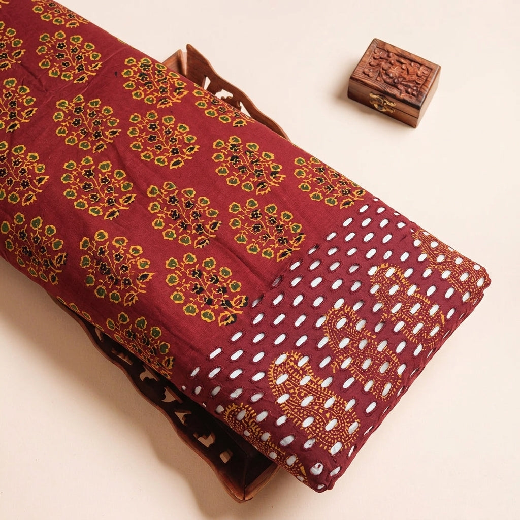 Cutwork Maroon Cutwork Cotton Fabric on a wooden tray