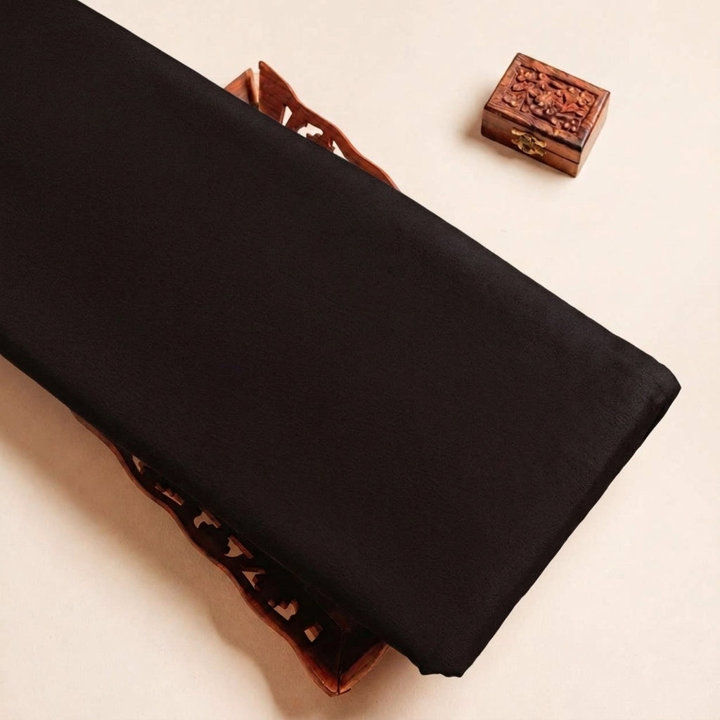 Folded Black Plain Crepe Fabric Highlighting Lining and Texture