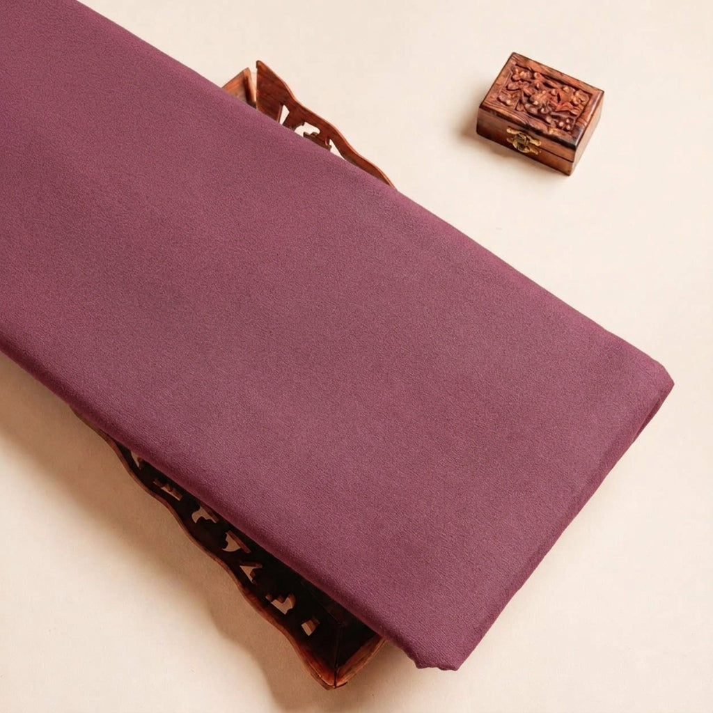 Folded Dusty Pink Plain Crepe Fabric Highlighting Lining and Texture