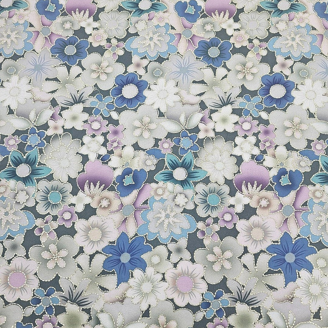 A close-up of a floral patterned fabric or wallpaper featuring white, light blue, lavender, and purple flowers with gray outlines on a dark gray background.