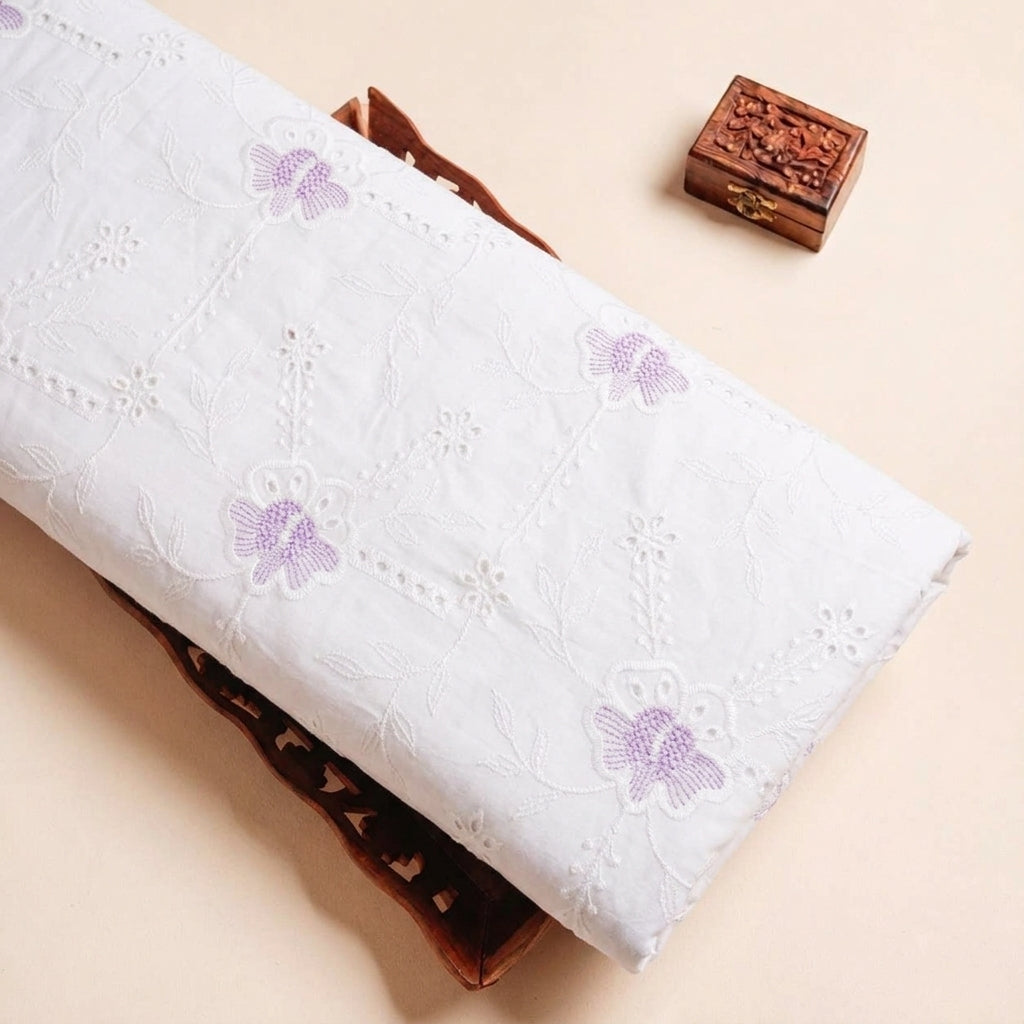 Folded White Embroidery Cotton Fabric Highlighting Floral Thread work and Texture