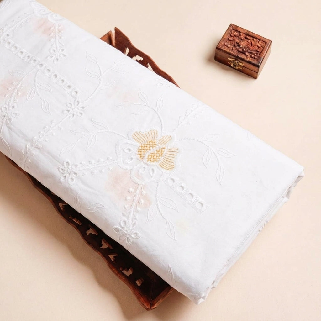 Folded White Embroidery Cotton Fabric Highlighting Floral Thread work and Texture