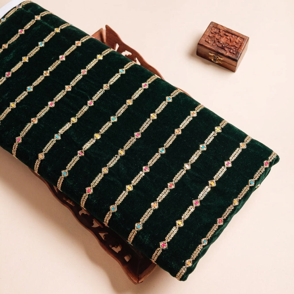 EMBROIDERY GREEN EMBROIDERY VELVET Fabric on a wooden tray