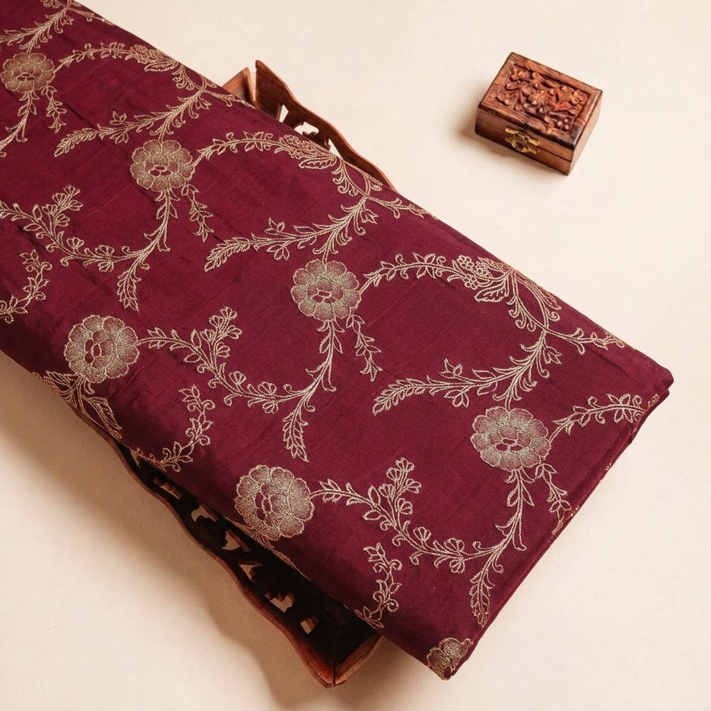 Folded Maroon Floral Viscose Organza Fabric Highlighting Zari and Texture