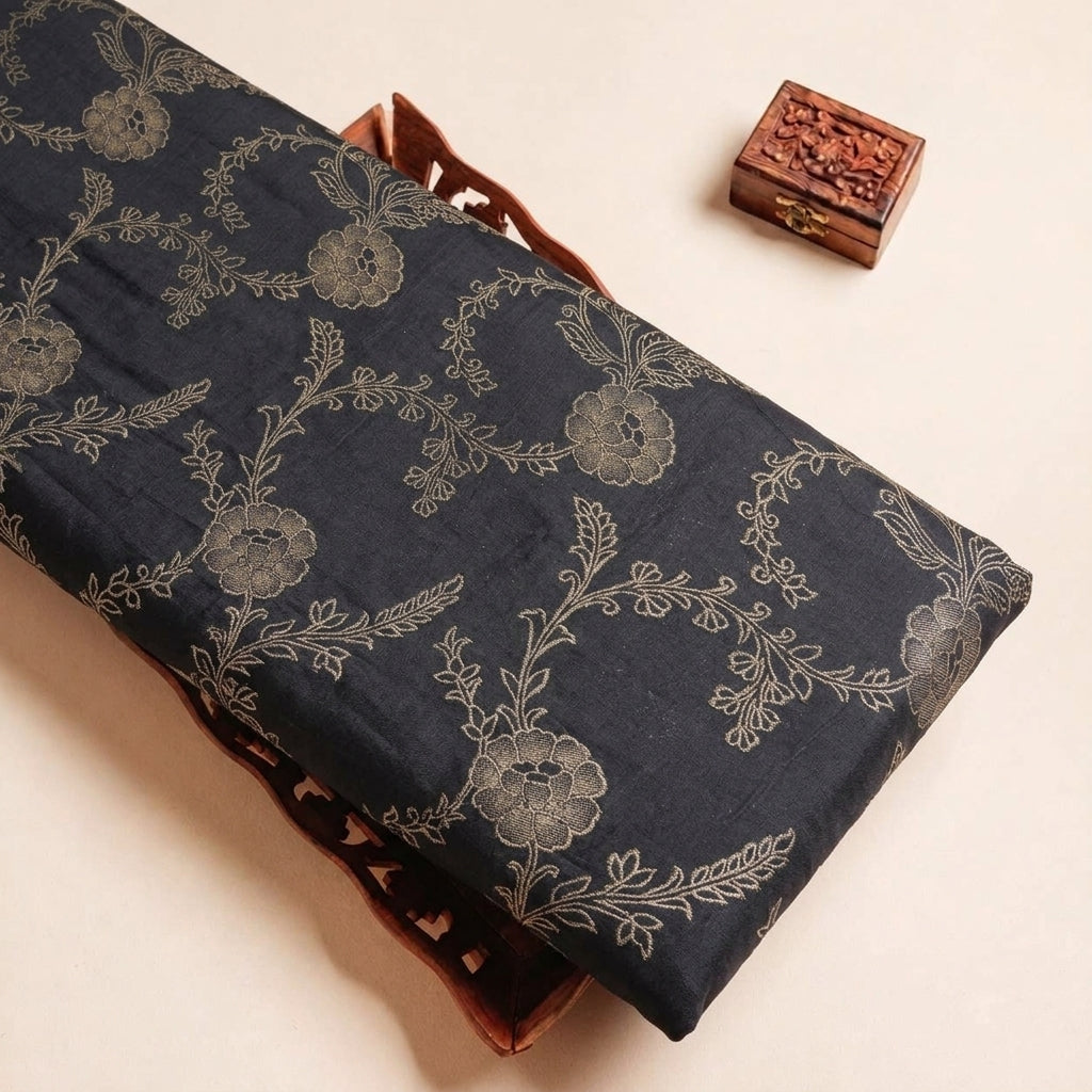 Folded Black Floral Viscose Organza Fabric Highlighting Zari and Texture