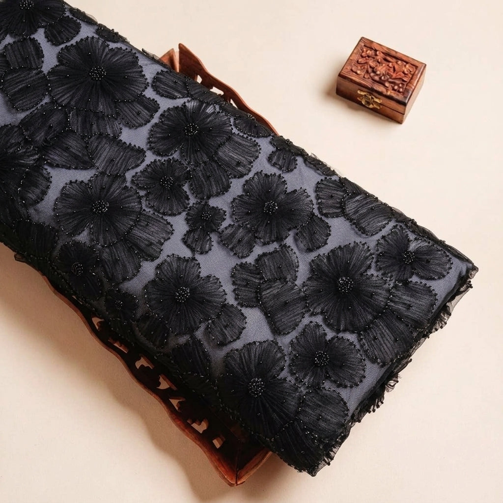 Folded Black Floral Embroidery Net Fabric Highlighting Floral Stone and Texture