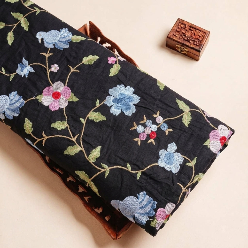 Folded Black Embroidery Tussar Fabric Highlighting Floral Thread Work and Texture