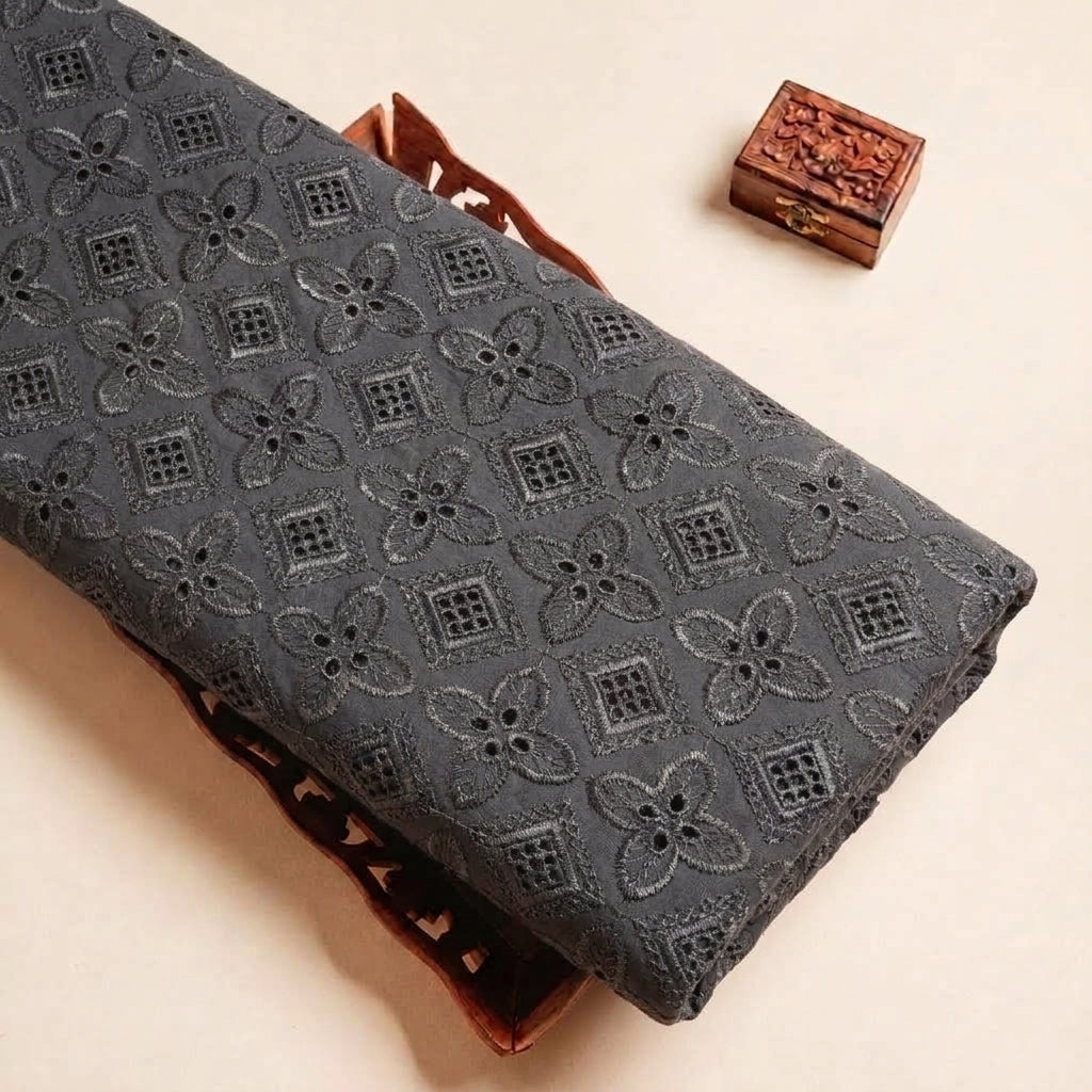 Folded Black Embroidery Cotton Fabric Highlighting Floral and Texture