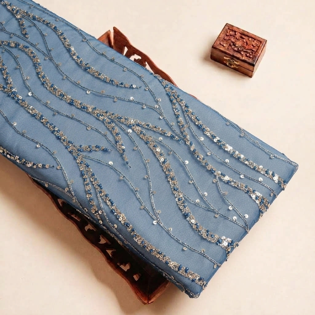 Folded Blue Embroidery Net Fabric Highlighting Stone Sequin Zari and Texture