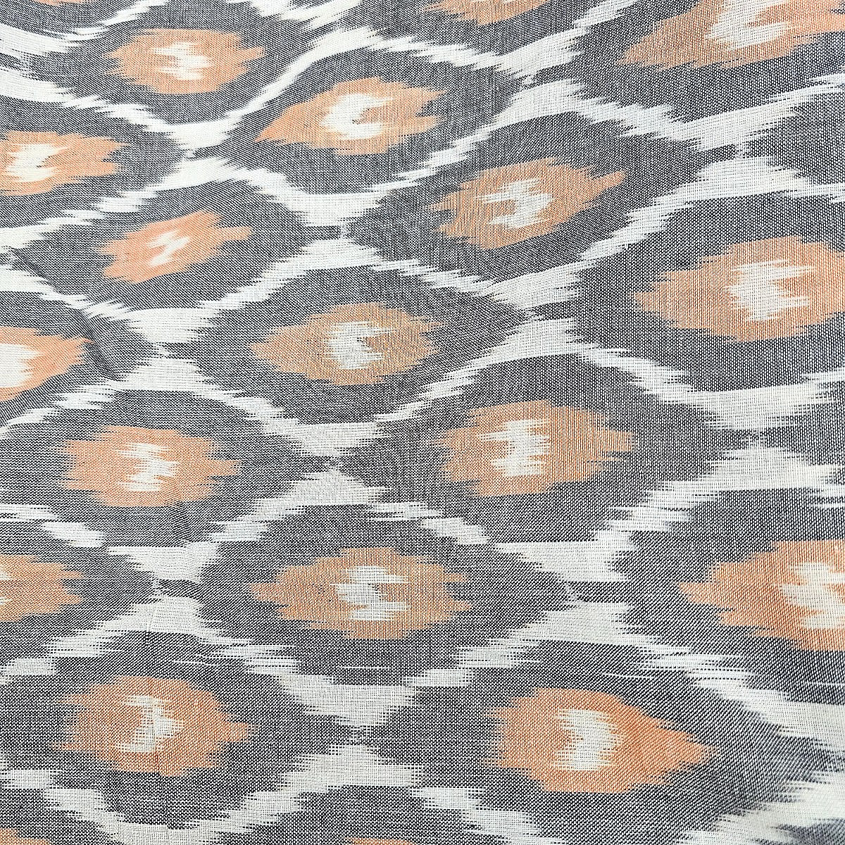 Orange Ikat Cotton Fabric, laid flat