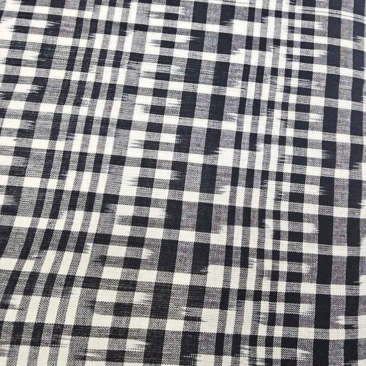 White Ikat Cotton Fabric, laid flat