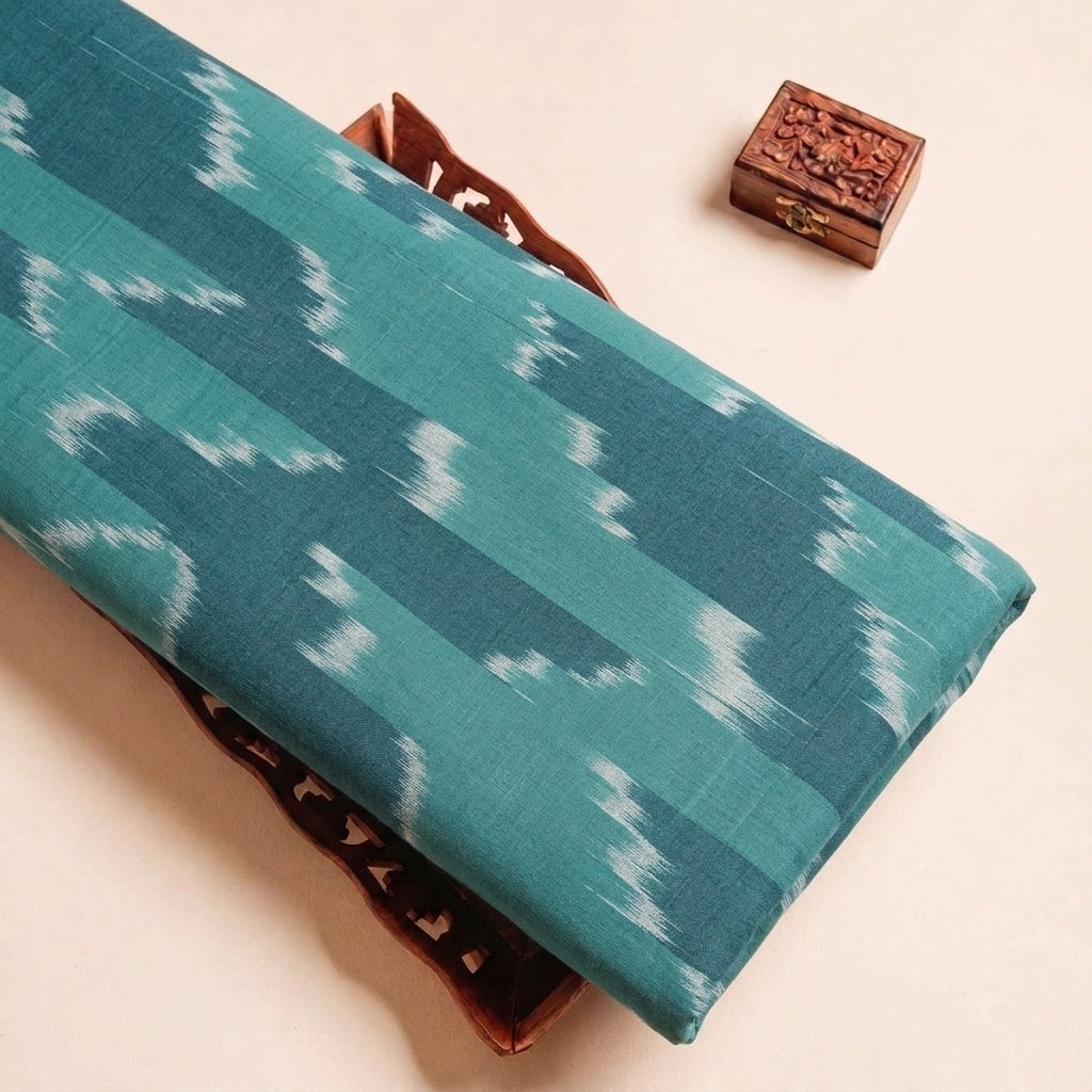 Folded Green Ikat Cotton Fabric Highlighting Texture