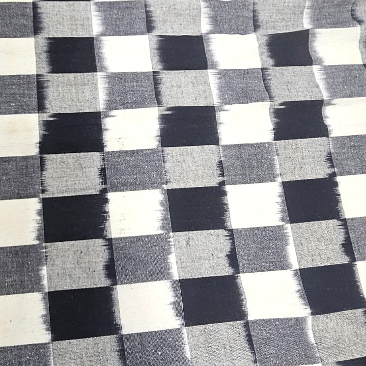White Ikat Cotton Fabric, laid flat