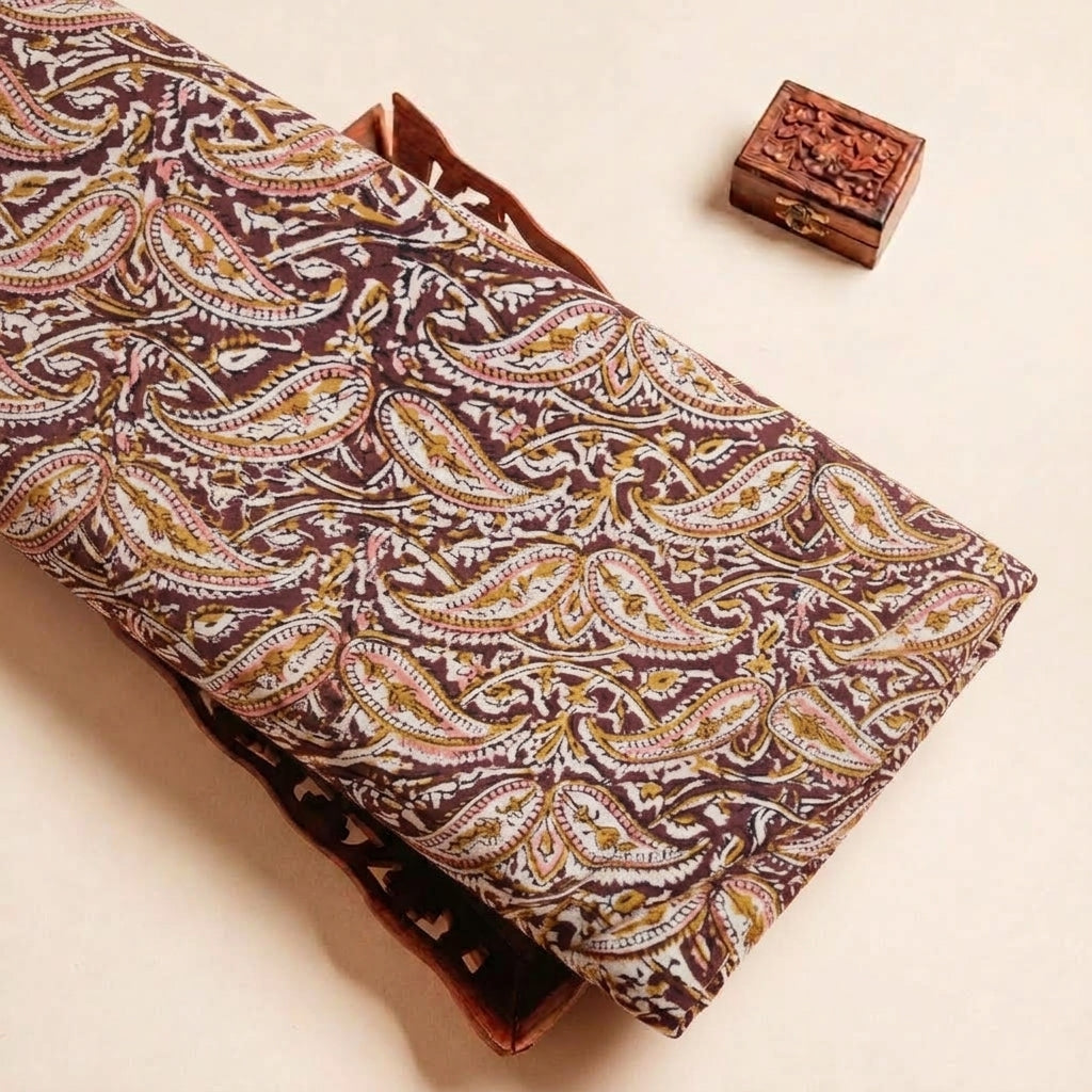 Folded Maroon Kalamkari Cotton Fabric Highlighting Texture
