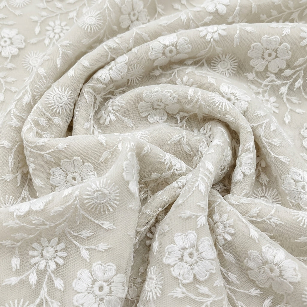 Swirled White Embroidery Net Fabric Showing Floral Thread Work and Drape