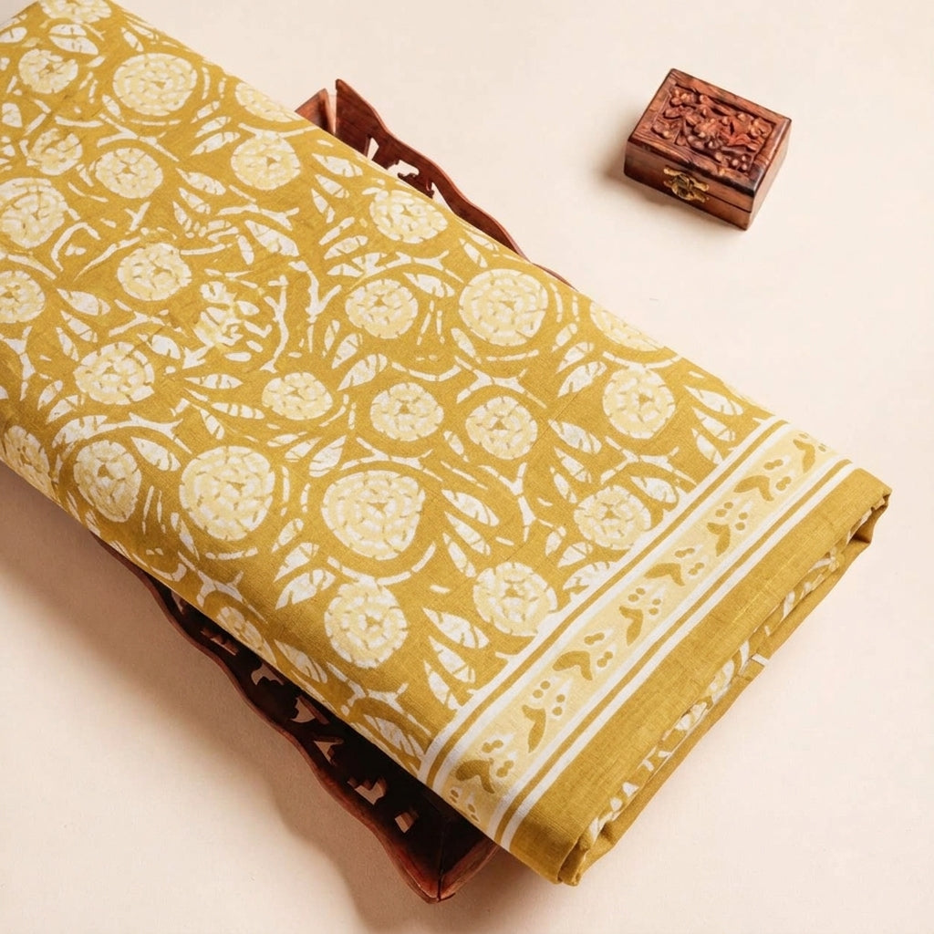 Folded Mustard Yellow Floral Cotton Fabric Highlighting Border and Texture