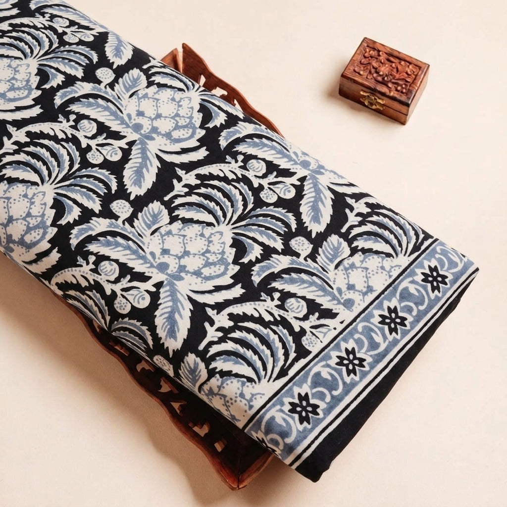 Folded Black Floral Cotton Fabric Highlighting Border and Texture