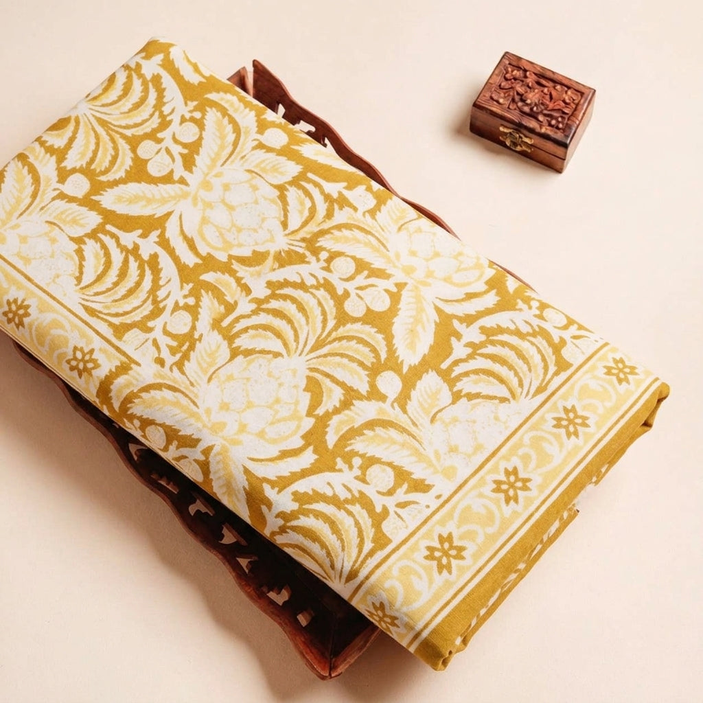 Folded Mustard Yellow Floral Cotton Fabric Highlighting Border and Texture