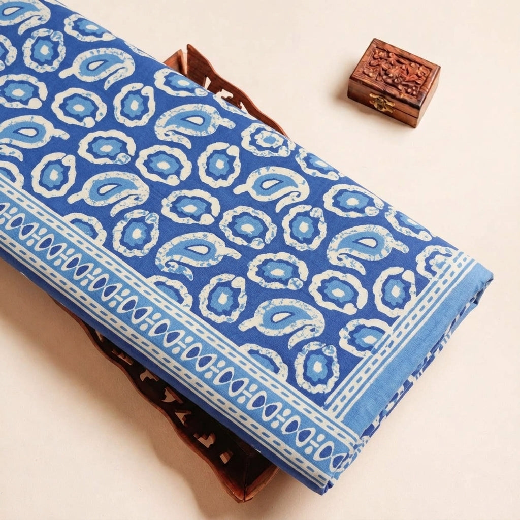 Folded Blue Paisley Cotton Fabric Highlighting Border and Texture