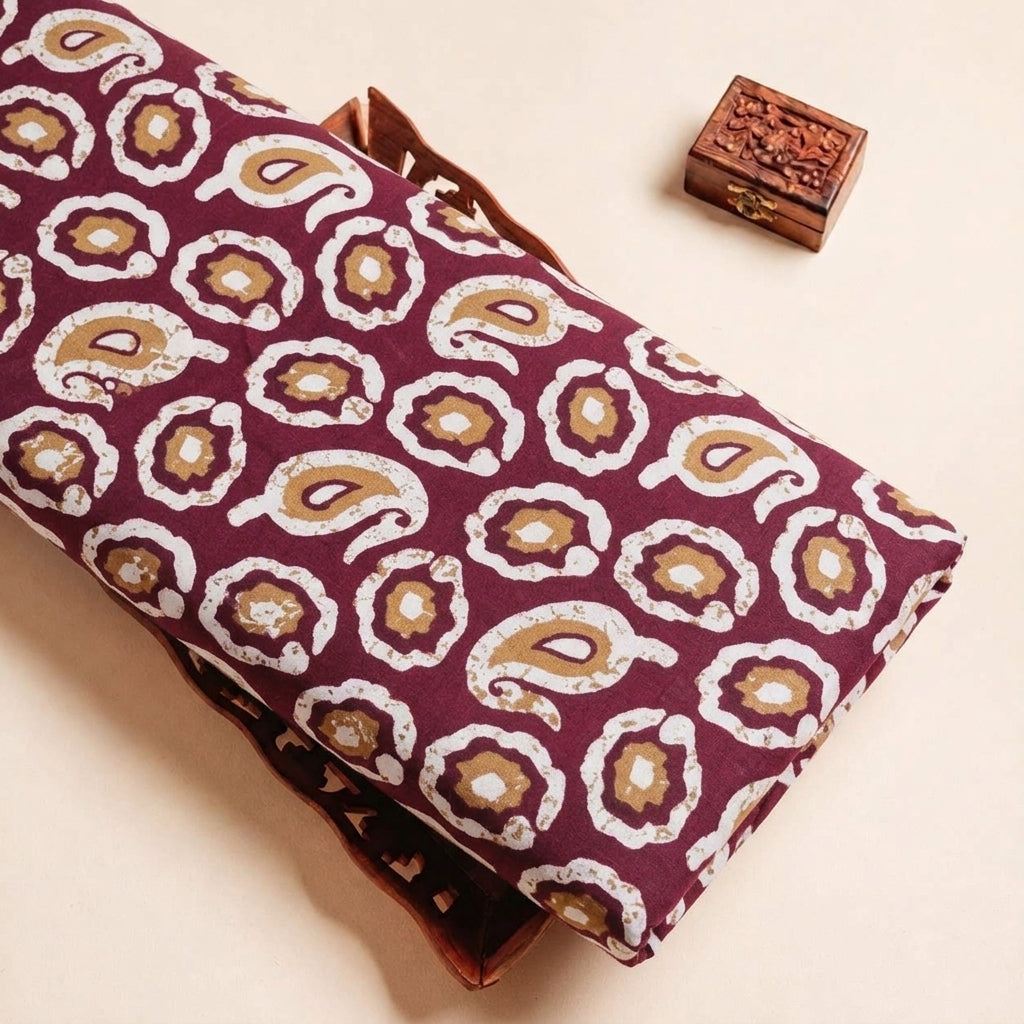 Folded Wine Paisley Cotton Fabric Highlighting Border and Texture
