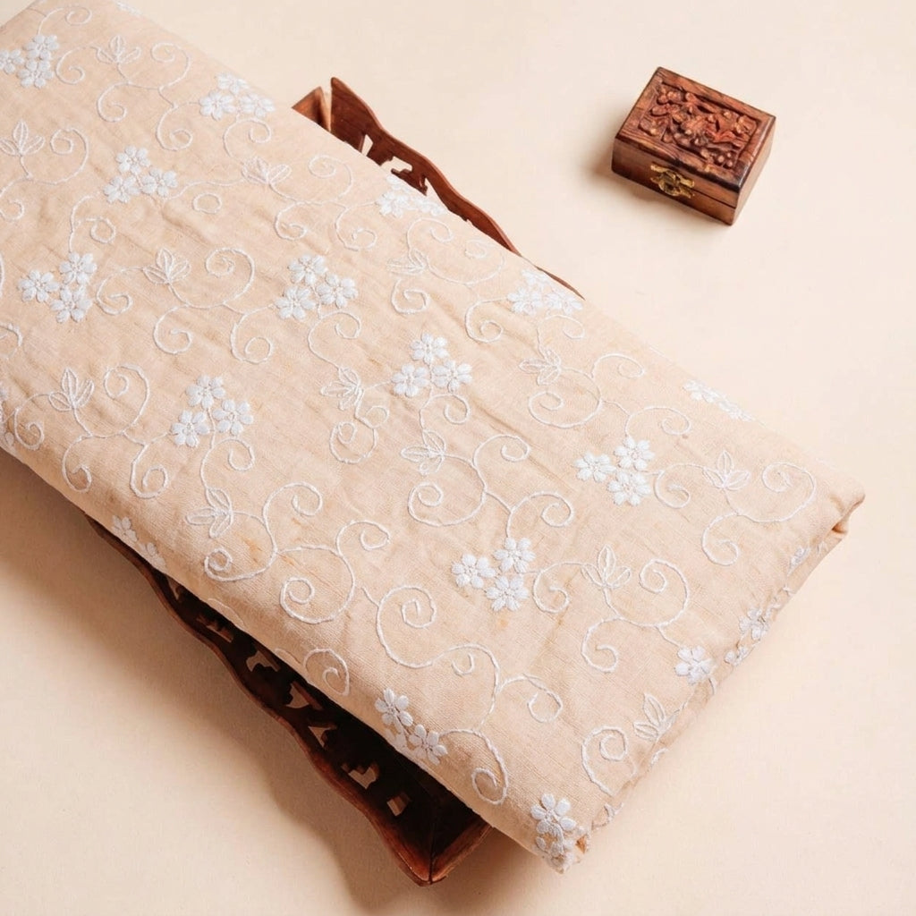 Folded Peach Embroidery Cotton Fabric Highlighting Floral Thread Work and Texture