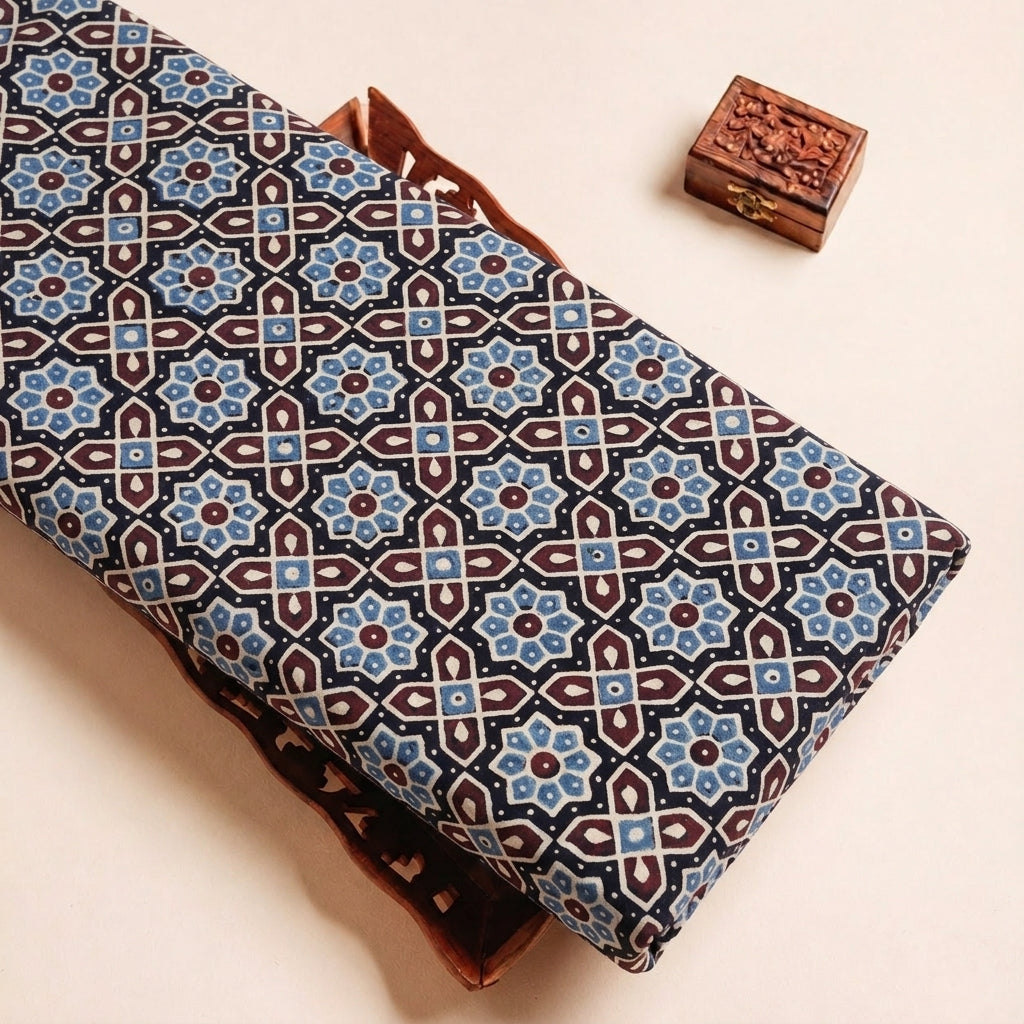 Folded Black Ajrakh Cotton Fabric Highlighting Block Print and Texture