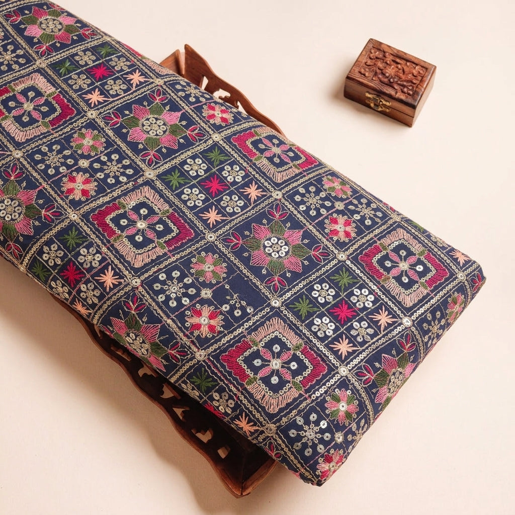 Embroidery Navy Blue Embroidery Georgette Fabric on a wooden tray
