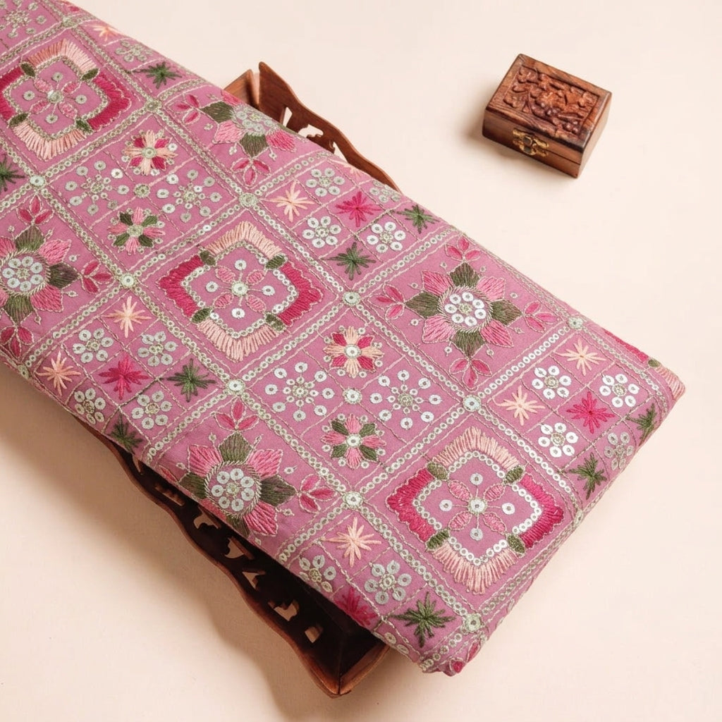 Embroidery Pink Embroidery Georgette Fabric on a wooden tray