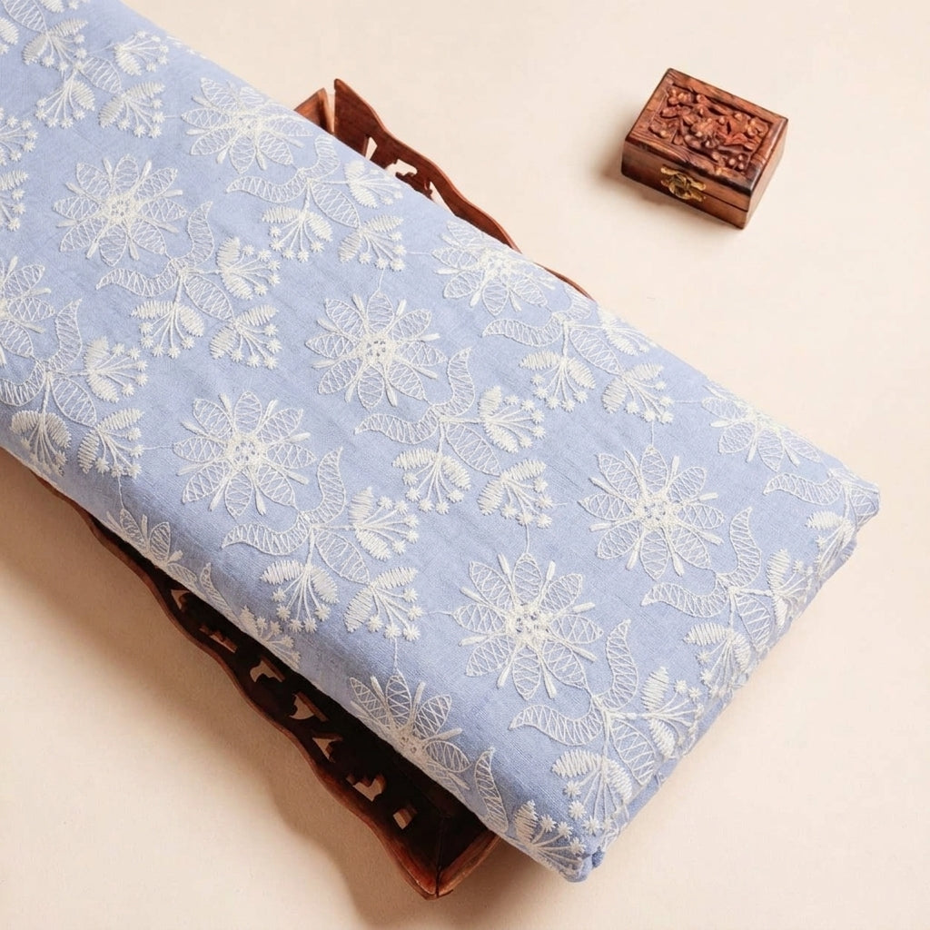 Folded Blue Embroidery Cotton Fabric Highlighting Thread Work and Texture