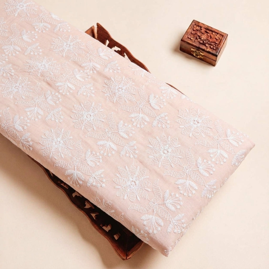 Folded Peach Embroidery Cotton Fabric Highlighting Thread Work and Texture
