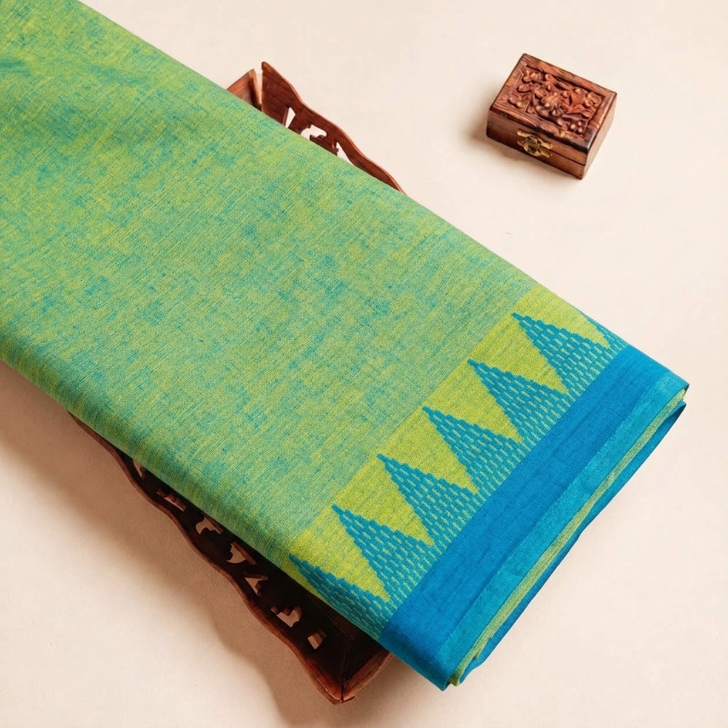 Folded Green Zari Border Cotton Fabric Highlighting Zari and Texture
