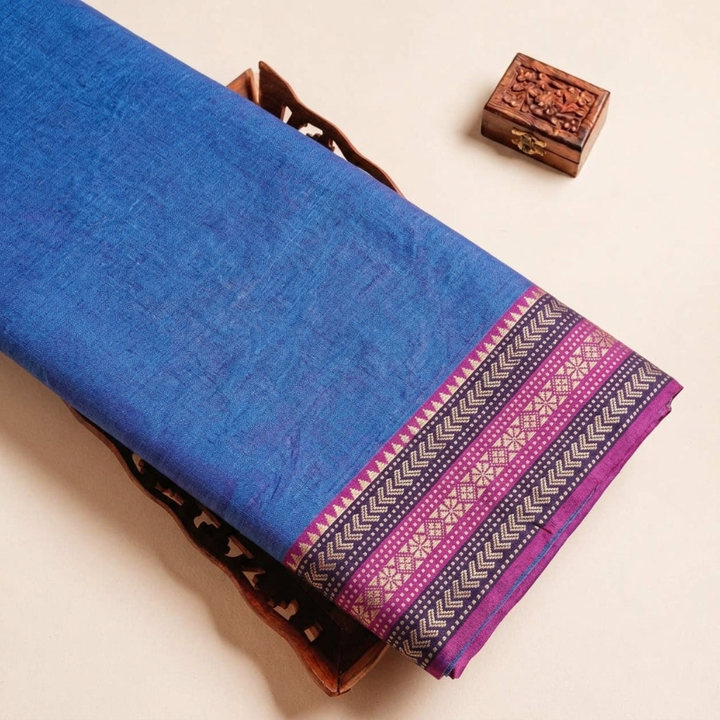 Folded Blue Zari Border Cotton Fabric Highlighting Zari and Texture