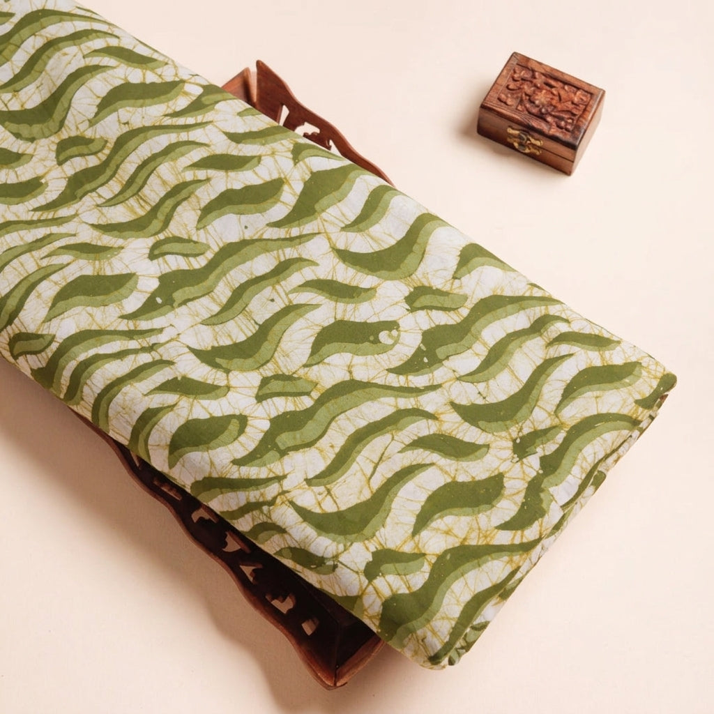 Batik Green Batik Cotton Fabric on a wooden tray