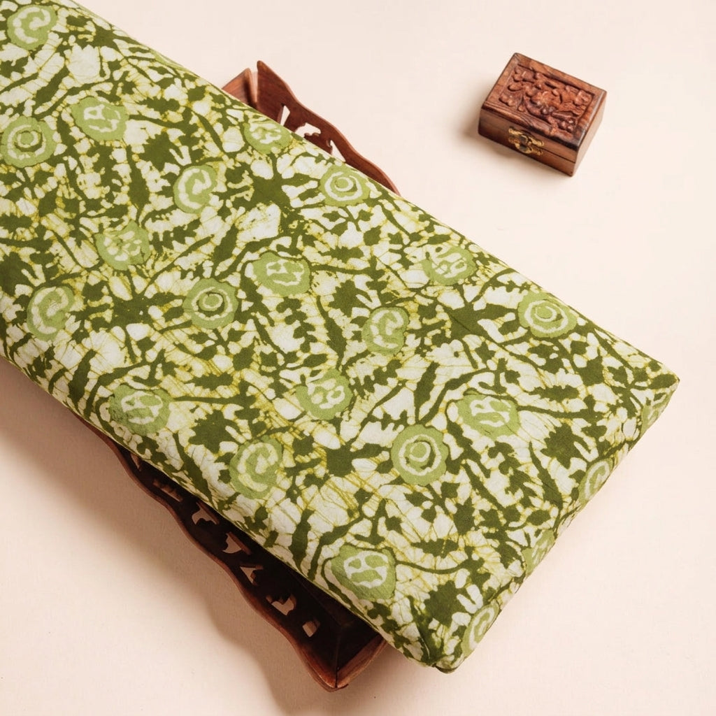 Batik Green Batik Cotton Fabric on a wooden tray