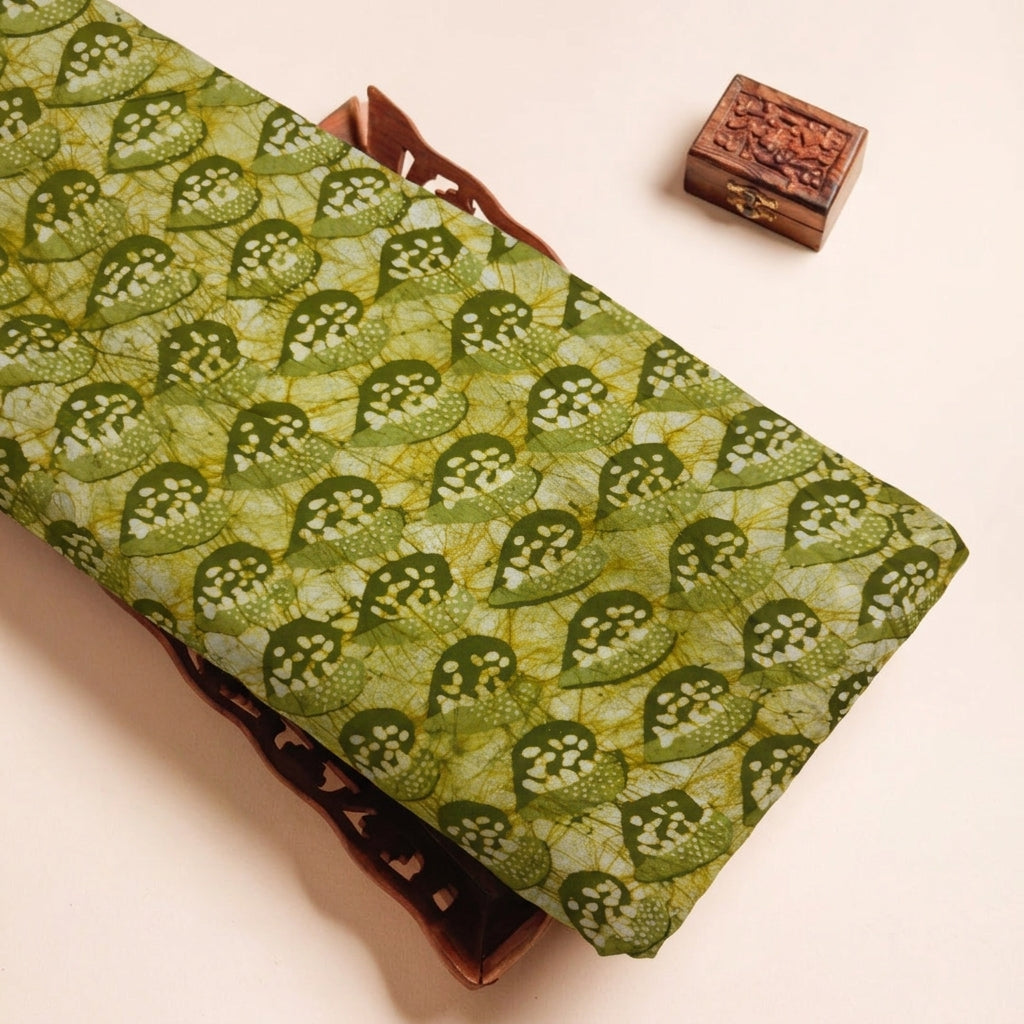 Batik Green Batik Cotton Fabric on a wooden tray