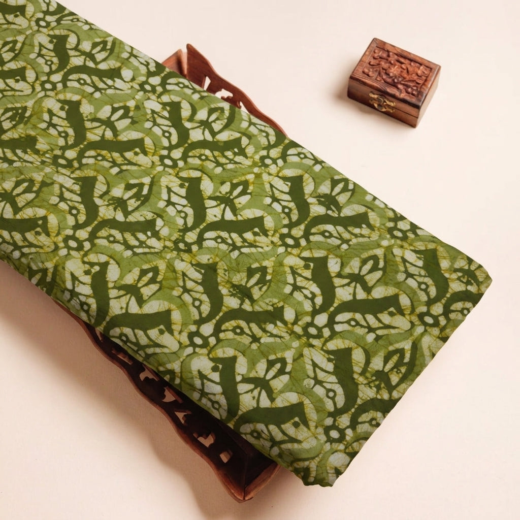 Batik Green Batik Cotton Fabric on a wooden tray