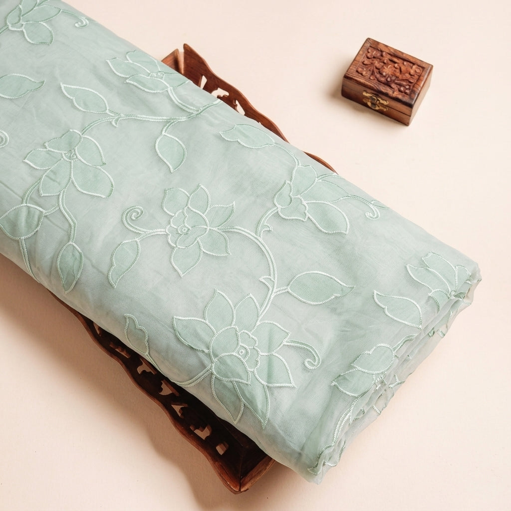 Embroidery Green Embroidery Tissue Fabric on a wooden tray