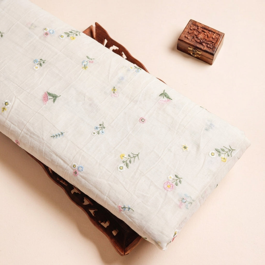 Embroidery Cream Embroidery Chanderi Cotton Fabric on a wooden tray