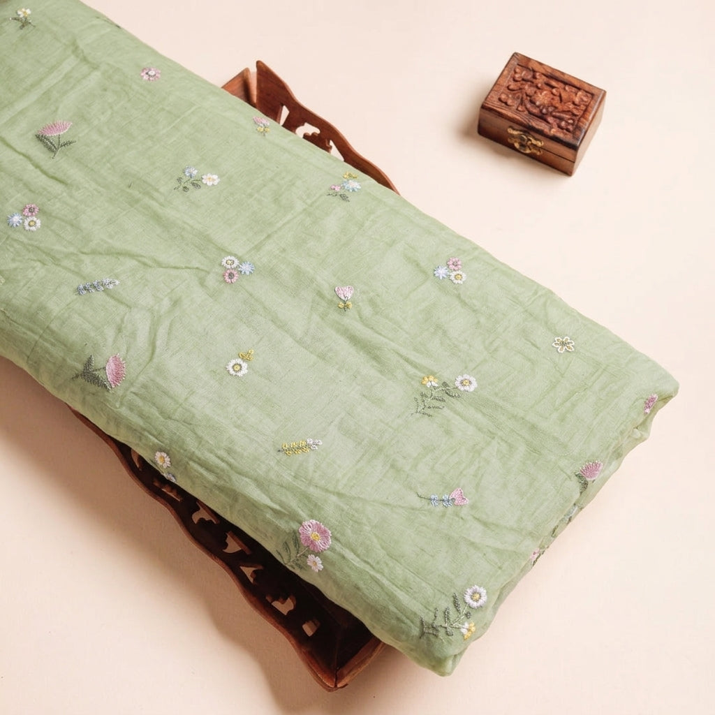 Embroidery Green Embroidery Chanderi Cotton Fabric on a wooden tray