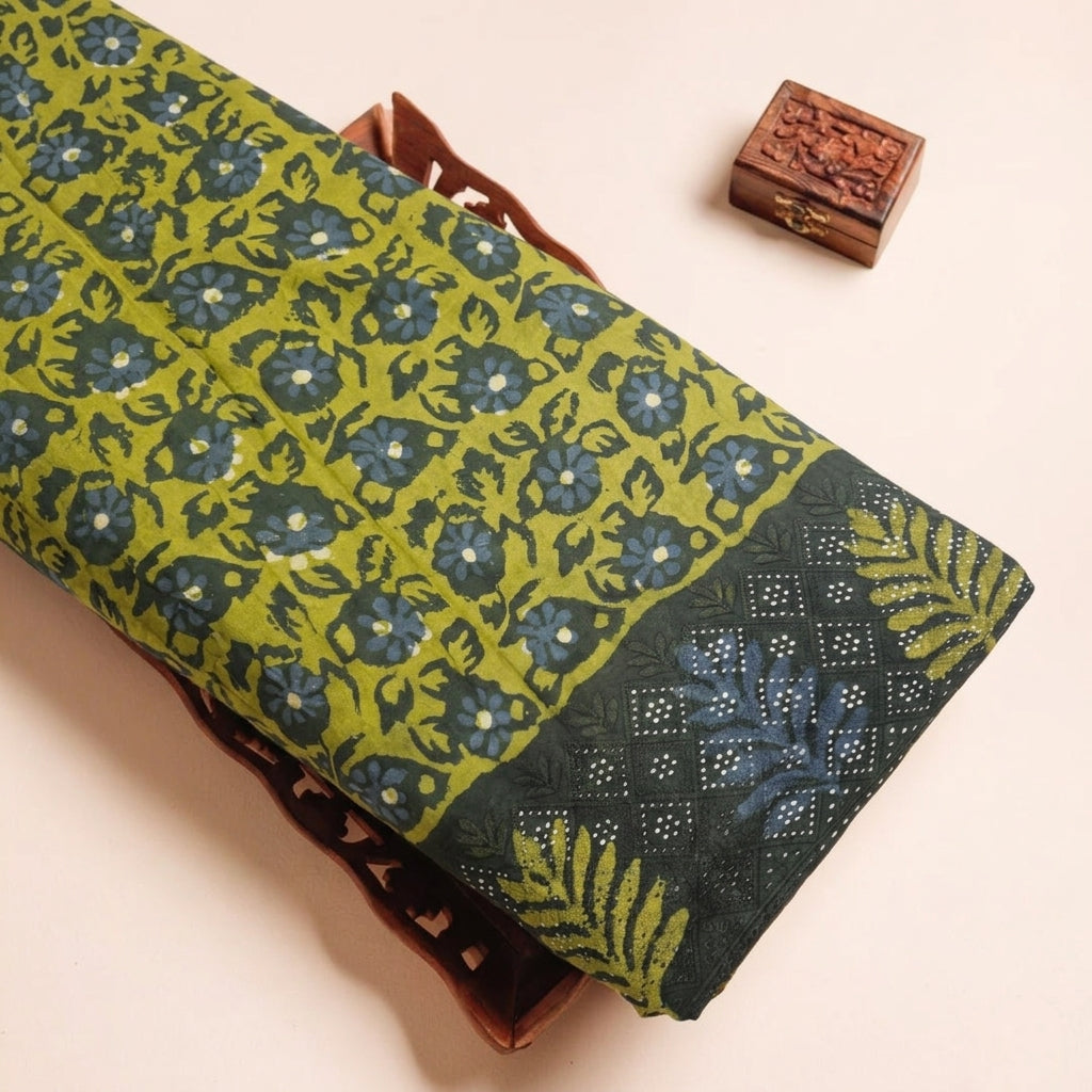 Batik Green Batik Cotton Fabric on a wooden tray