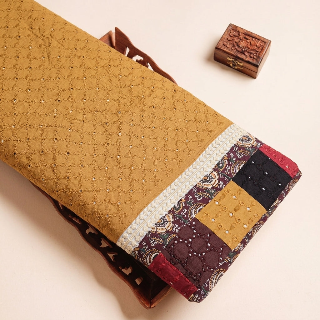 Cutwork Mustard Yellow Cutwork Cotton Fabric on a wooden tray