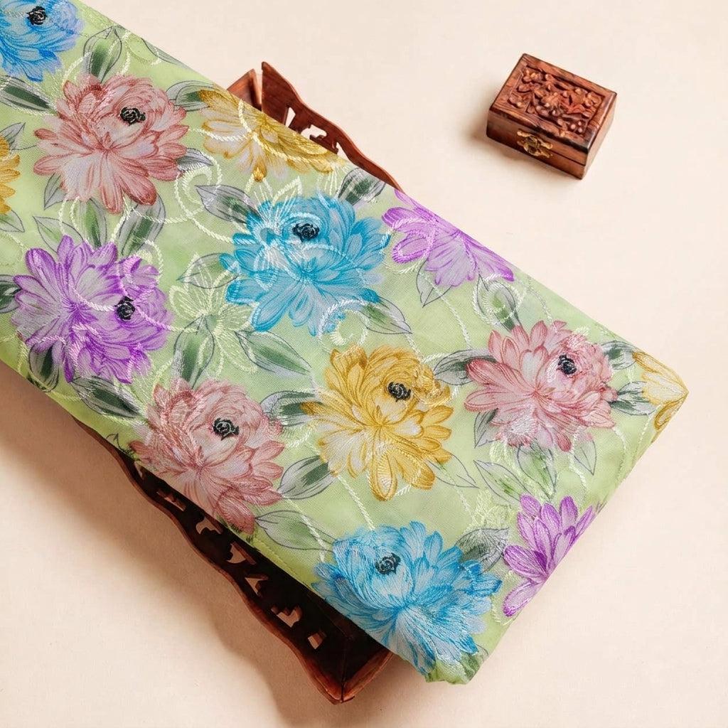 Folded Green Embroidery Cotton Fabric Highlighting Floral Thread work and Texture