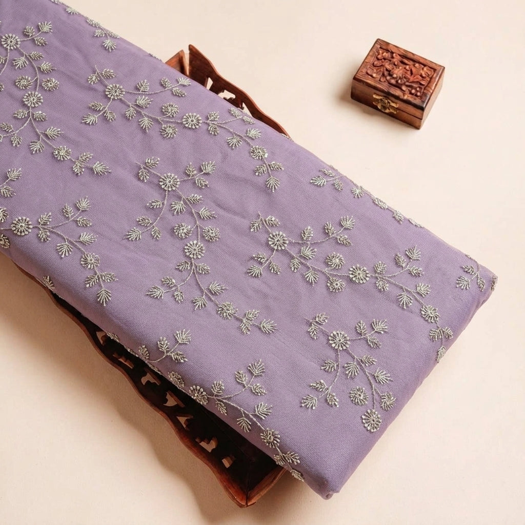 Folded Purple Embroidery Net Fabric Highlighting Floral Thread work Sequin and Texture