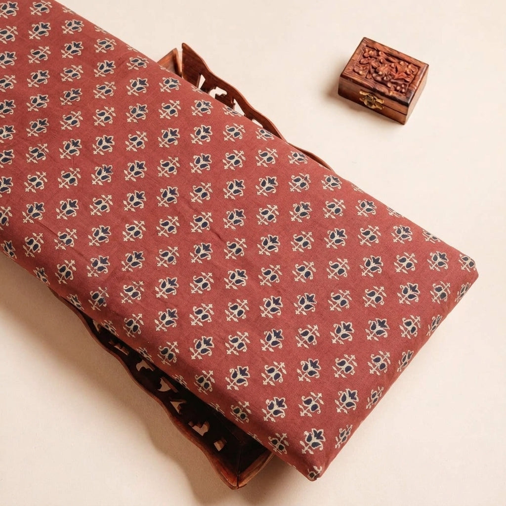 Folded Maroon Ajrakh Modal Silk Fabric Highlighting Block Print and Texture