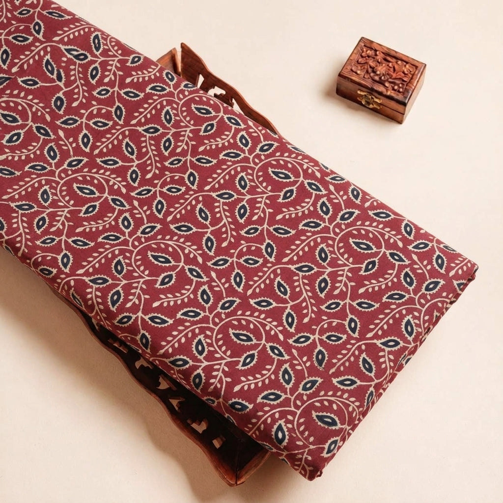 Folded Maroon Ajrakh Modal Silk Fabric Highlighting Block Print and Texture