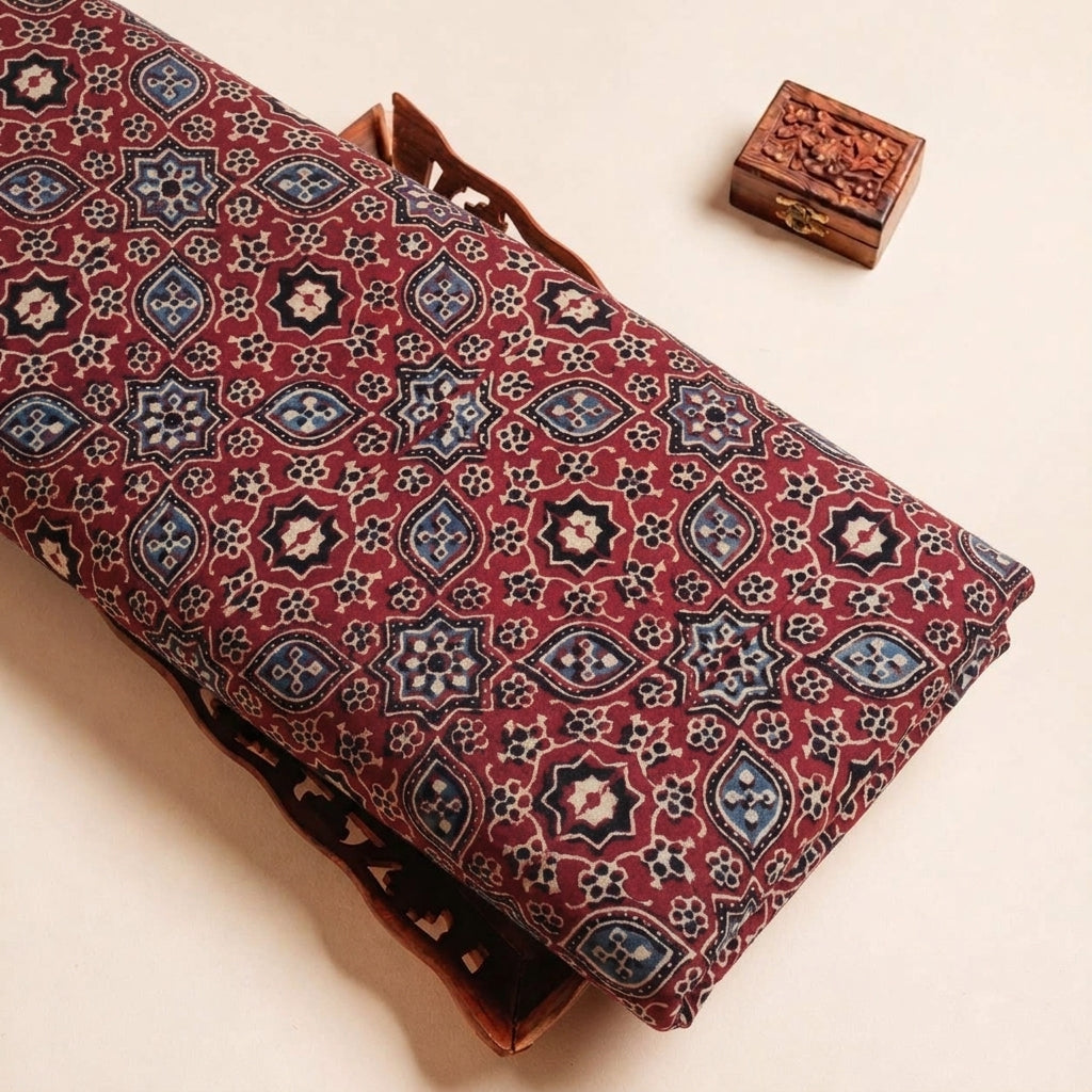 Folded Maroon Ajrakh Modal Silk Fabric Highlighting Silk Block Print and Texture