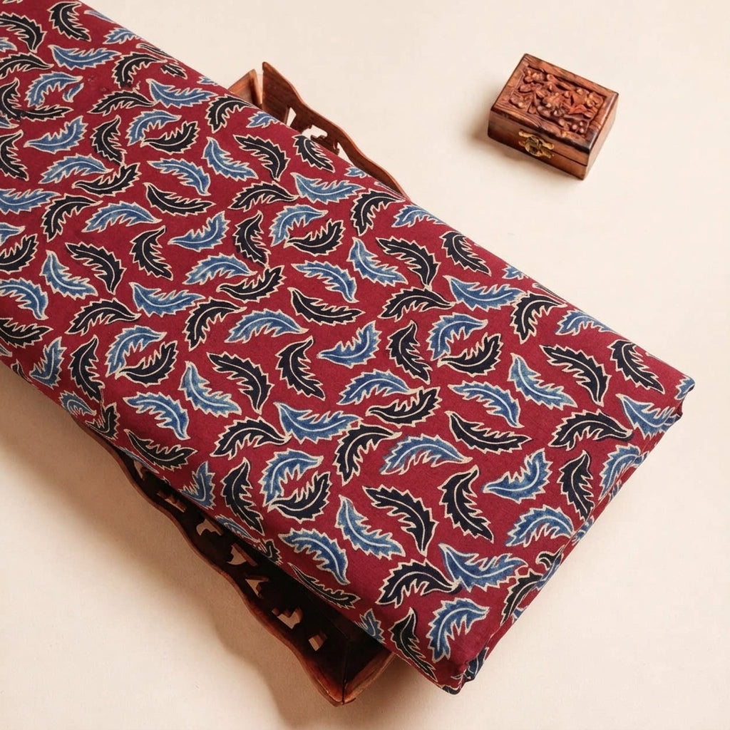 Folded Maroon Ajrakh Modal Silk Fabric Highlighting Leaf Silk Block Print and Texture