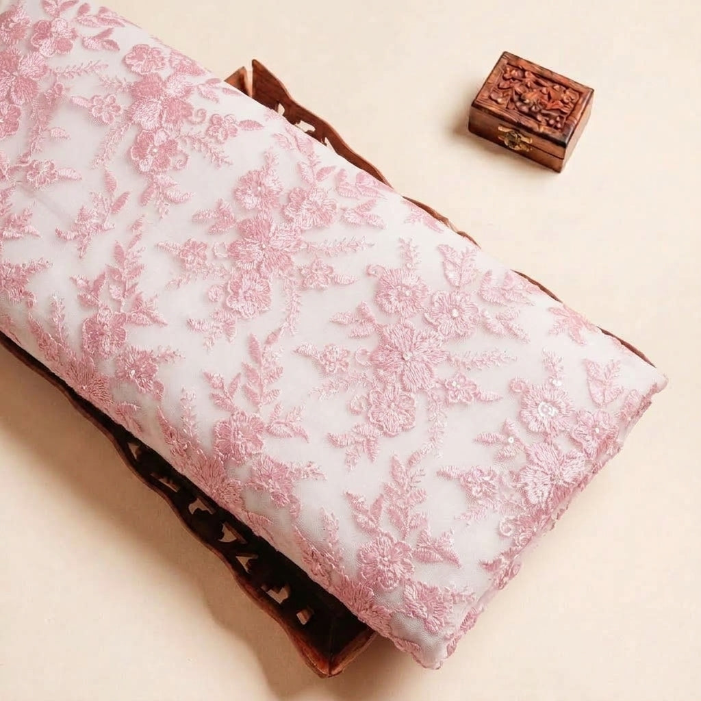 Folded Pink Embroidery Net Fabric Highlighting Sequin Floral Thread Work and Texture