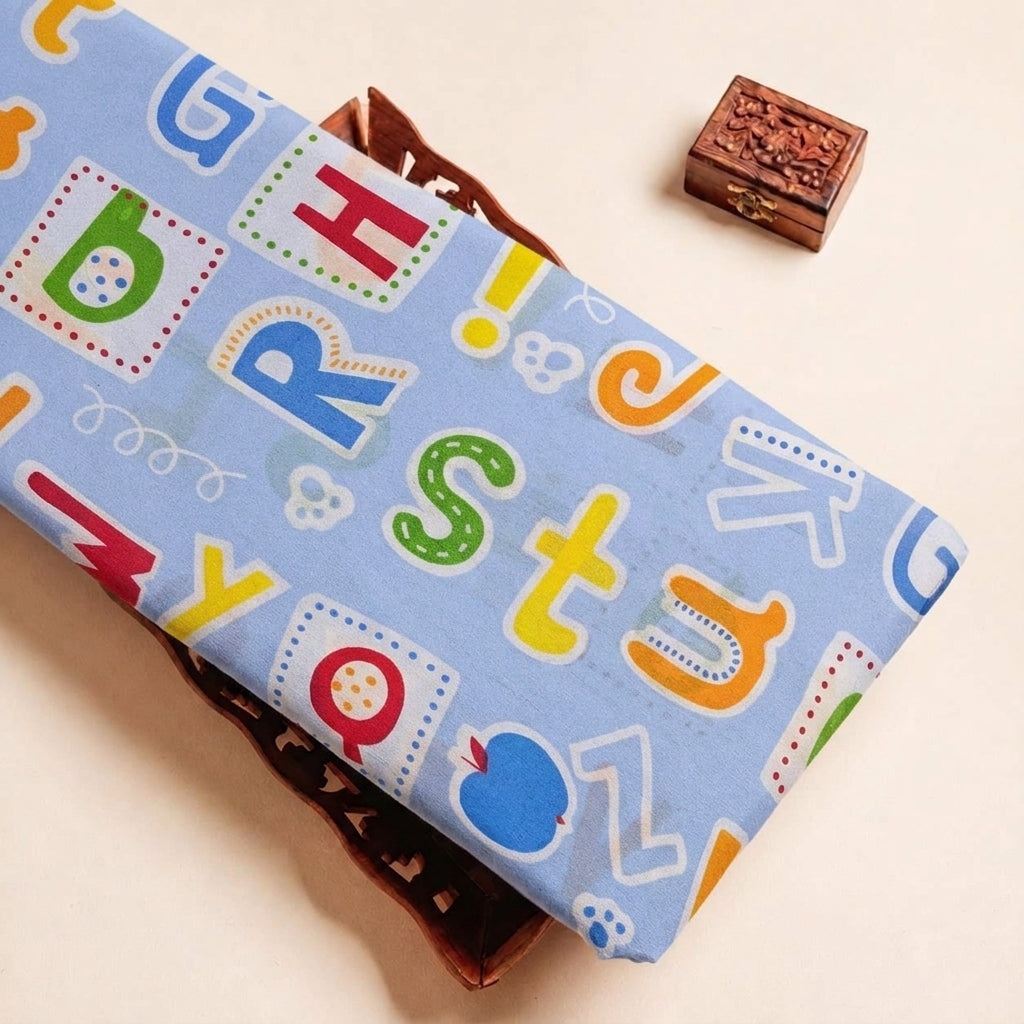 Folded Light Blue Printed Cotton Fabric Highlighting Kids and Texture