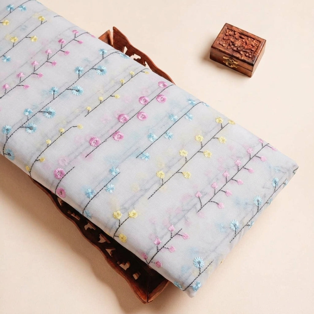 Folded White Embroidery Cotton Fabric Highlighting Thread Work Floral and Texture